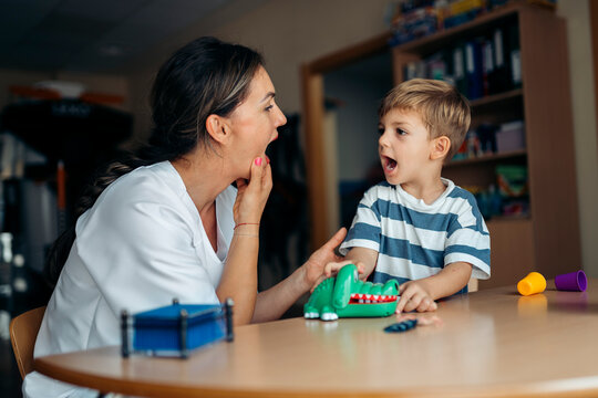 Speech therapist helping child with language development