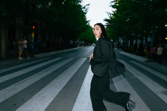 Woman Crossing a City Street