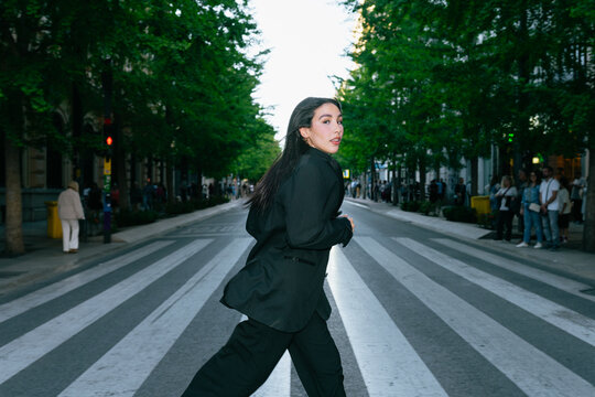 Woman Crossing Urban Street Artfully