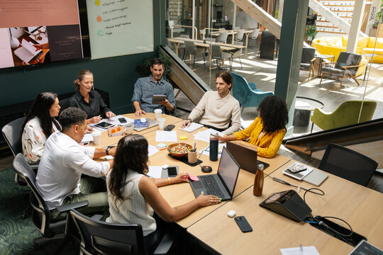 Diverse team collaborating during a meeting in a modern room