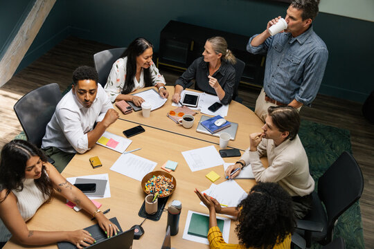 Collaborative business meeting with diverse team around table