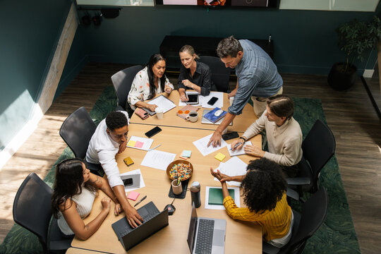 Collaborative business meeting with diverse team around table