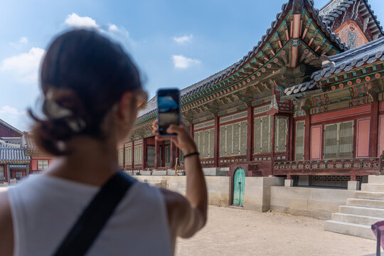 Woman Taking a Picture of Traditional Architecture in a Palace