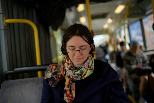 Thoughtful Moment on a City Bus Ride Towards Evening Light