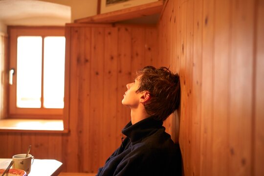 Contemplative Moment in a Cozy Wooden Room During the Afternoon