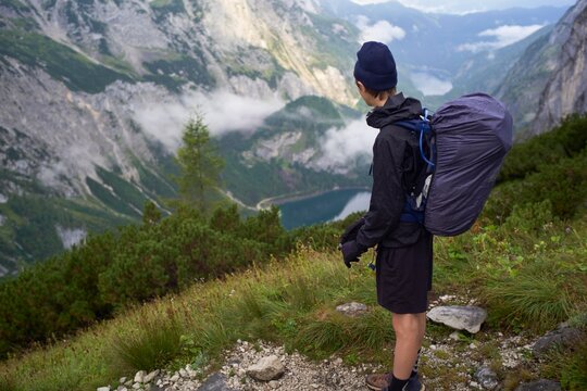 Stunning Mountain View With a Hiker Looking at the Lake Below