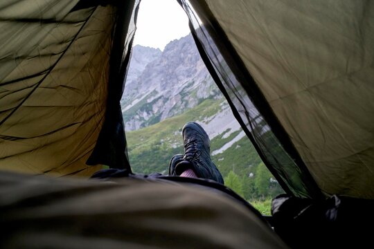 Relaxing in a Tent With a View of Mountains During a Camping Trip