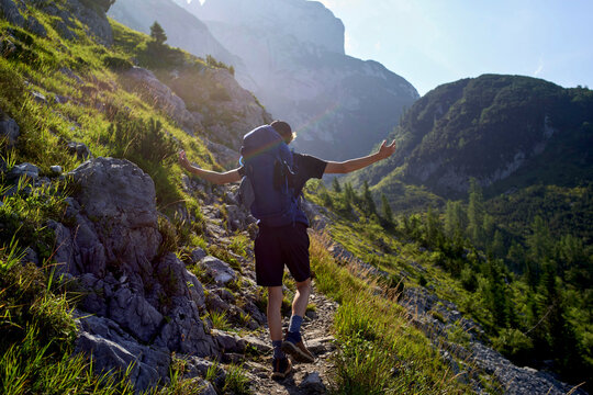 Hiker Enjoying the Mountain Trail During a Sunny Day