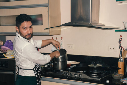 Chef prepares a meal in a modern kitchen while focused on cooking