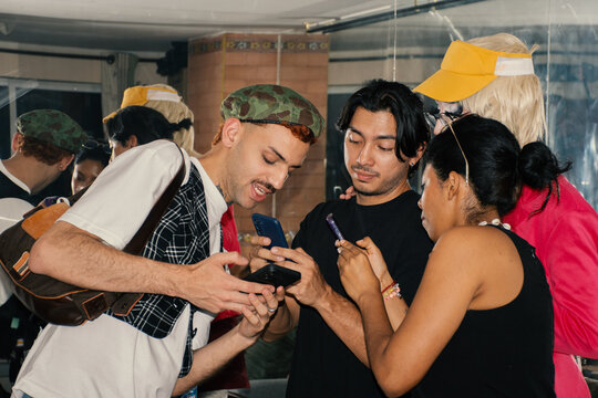 Friends sharing smartphones in a casual indoor setting