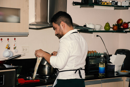 Man cooking in a modern kitchen preparing a meal