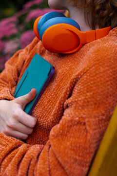 headphones on the neck and a tablet