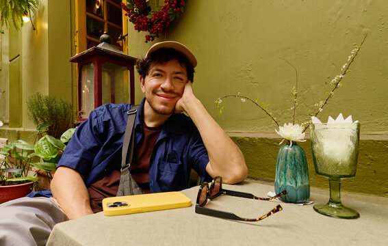 Man sitting at outdoor caf&eacute; table in Vietnam