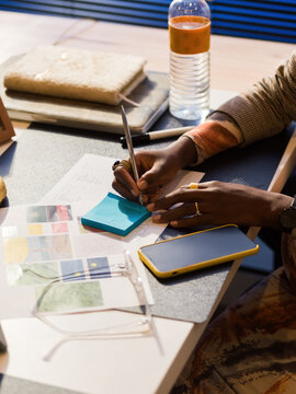 Businesswoman writing notes at her desk 