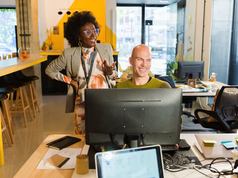 Cheerful colleagues working at office