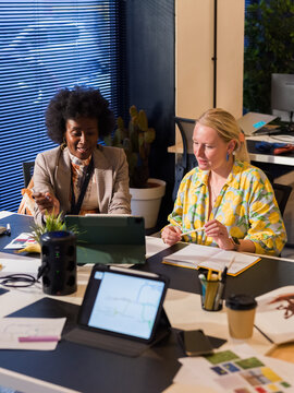 Cheerful colleagues having conversation at office 