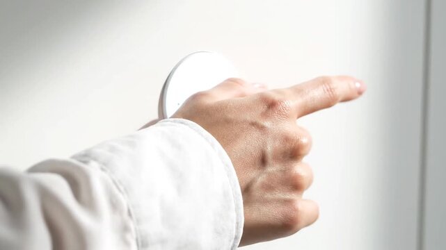 Hand Pressing Doorbell Closeup Gesture.