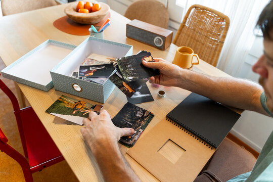 Man Looking At Photos