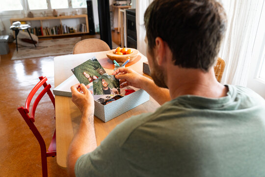 Man Sorting Printed Photos