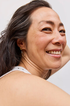 Asian woman with long dark hair in studio