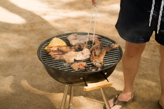 Grilling fresh meat at a nature campsite