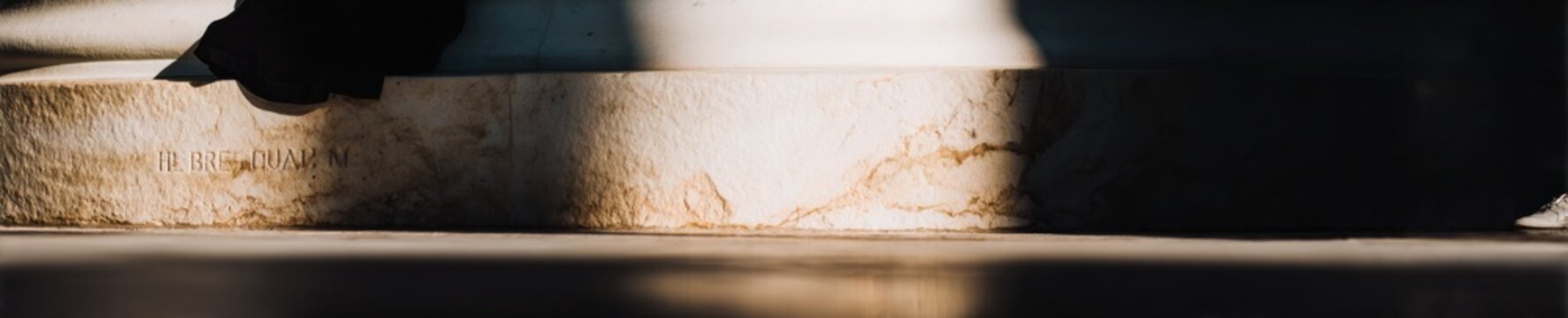 Engraved inalienable rights text on marble wall at historic memorial site with soft lighting for government and social justice design projects with copy space