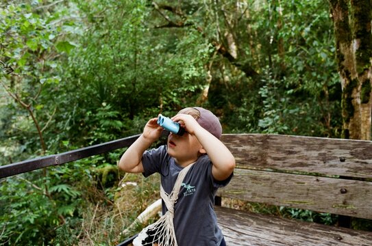 Child exploring nature with binoculars