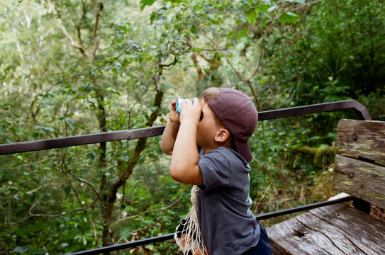 Child using binoculars to explore nature