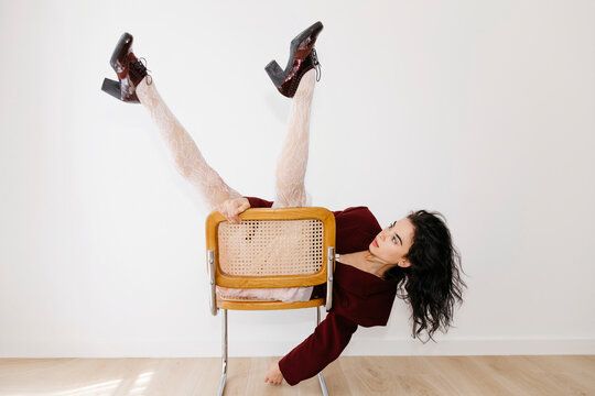 Woman posing flexibly on chair