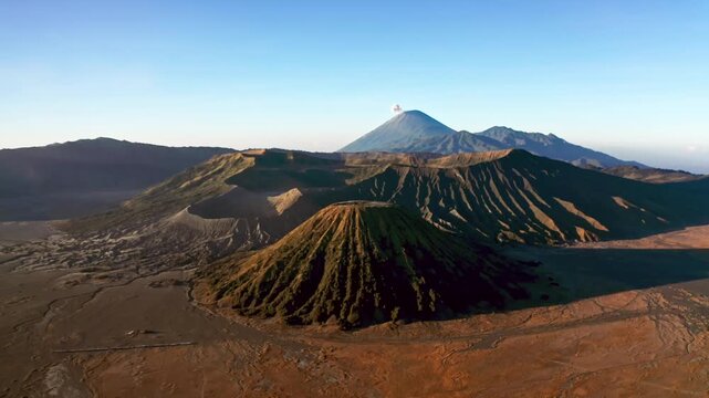 Aerial View Active Crater of Mount Bromo and Batok Volcano in East Java. Breathtaking Flying Drone Footage with Mist and Sand in Tengger Semeru National Park During Sunrise in Beautiful Indonesia 4k