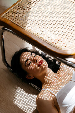 Woman with shadow patterns from sunlight