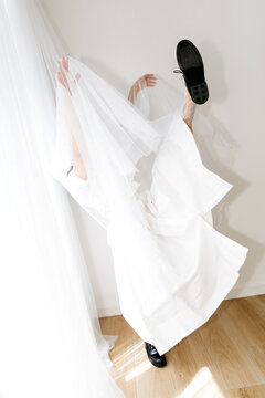 Dancer hiding under white tulle 