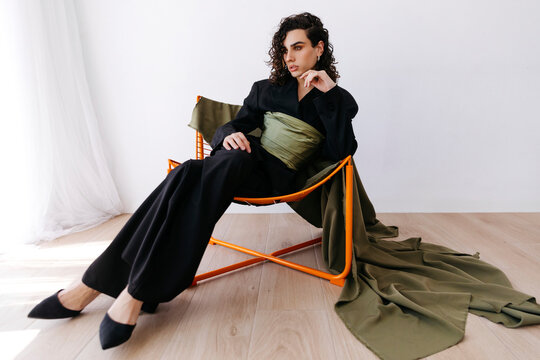 Queer man posing in stylish fashion outfit