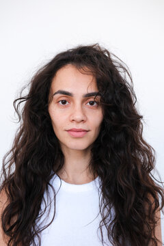 Portrait of a Woman With Curly Hair in a Minimalist Setting