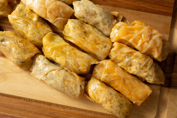 A top down view of stuffed cabbage, on a wood board.