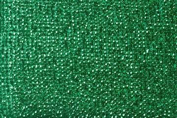 Fototapeta premium bright green plastic material texture background, shiny metallic finish with interwoven synthetic strands, full frame closeup, party theme background and festive concept