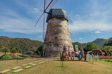 family Sitting by Dutch Windmill in a Garden