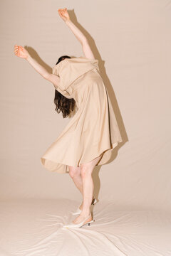 Beige Dress Dance Pose in Motion
