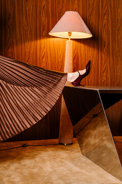 Elegant Leg Pose With Burgundy Heels On Table