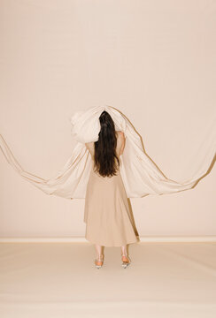 Beige Dress Model Draped In Flowing Fabric