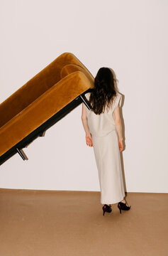 White Dress Figure With Tilted Sofa