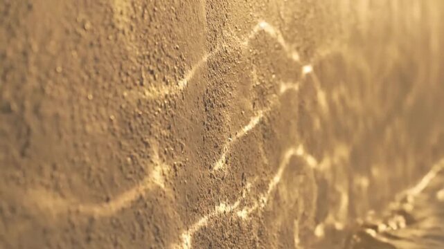 Close-up shot of a textured, golden surface with a cracked pattern and a white border at the bottom, with warm, earthy tones conveying a sense of aged luxury.