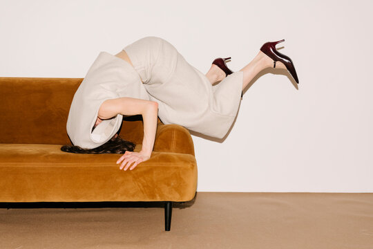 Bold Fashion Pose On Sofa With Heels