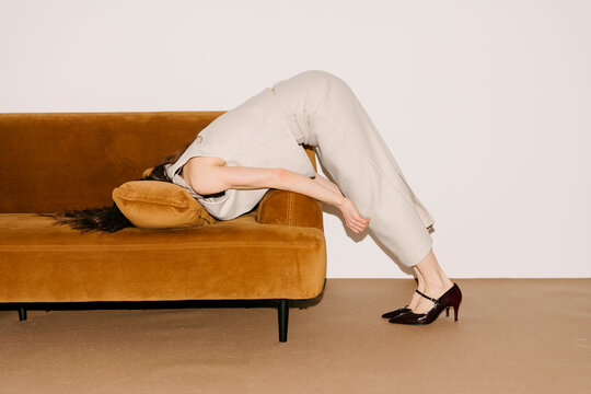 Relaxed Yet Striking Pose On Brown Sofa