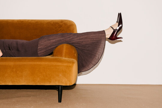 Elegant Leg Rest on Velvet Orange Sofa
