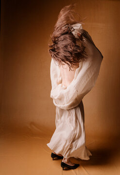 Silhouette Of Woman In White Dress Twirling