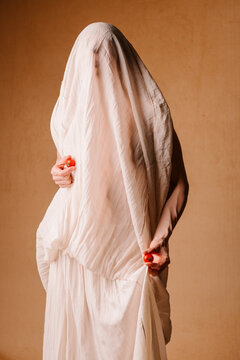 Hidden Figure Draped in White Cloth With Red Orbs