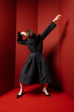 Dramatic Black Attire Dancer In Red Studio