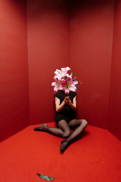Pink Lily Bouquet Obscures Face In Red Room