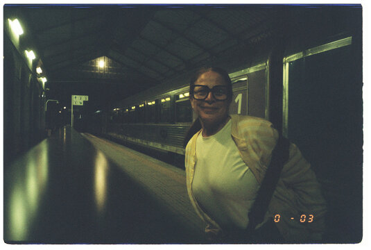 Woman Smiling at empty Train Station